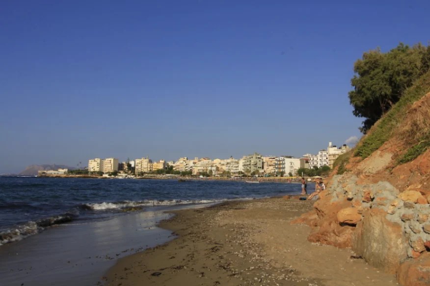 Plaża Nea Chora z widokiem na miasto Chania w tle, popularne miejsce wypoczynku na Krecie.